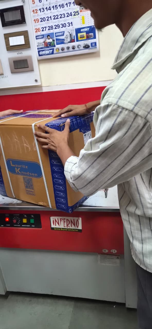 A Lauritz Knudsen carton being strapped on a strapping machine before dispatch