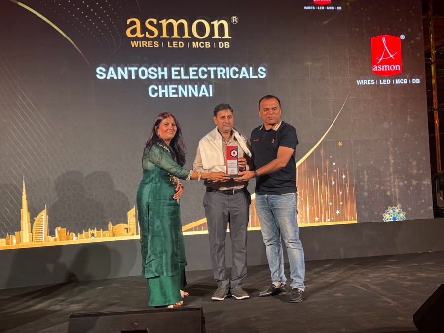 Narayan Mali receiving the Asmon dealer excellence award on stage for Santosh Electricals Chennai
